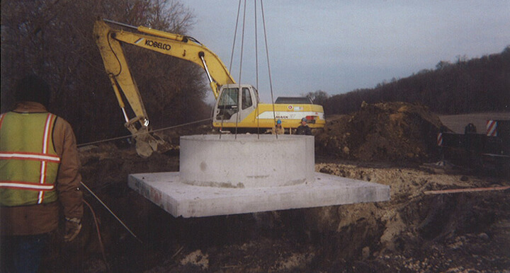 Septic Services: concrete septic tank cover being lifted into place